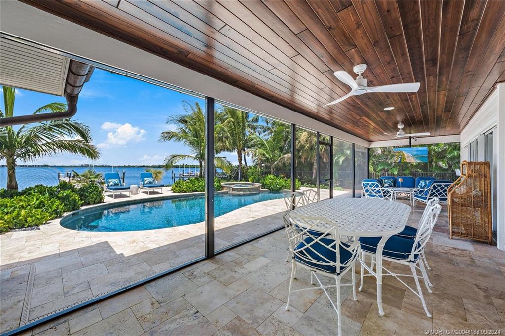 4110 Northeast Joes Point Road Stuart, FL 34996 - Photo 11 of 67 a view of a patio with table and chairs and potted plants