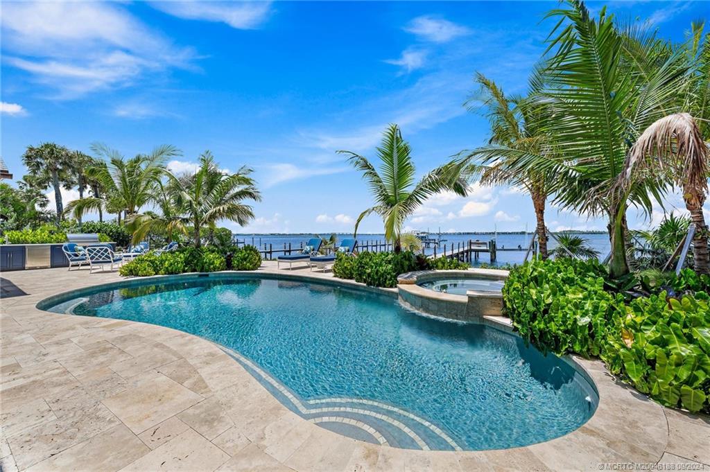 4110 Northeast Joes Point Road Stuart, FL 34996 - Photo 12 of 67 a view of a swimming pool and lounge chair