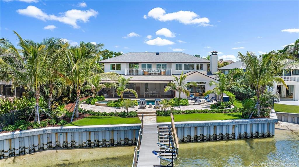 4110 Northeast Joes Point Road Stuart, FL 34996 - Photo 15 of 67 a front view of a house with swimming pool having outdoor seating