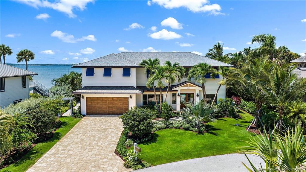 4110 Northeast Joes Point Road Stuart, FL 34996 - Photo 2 of 67 a front view of a house with a yard and potted plants