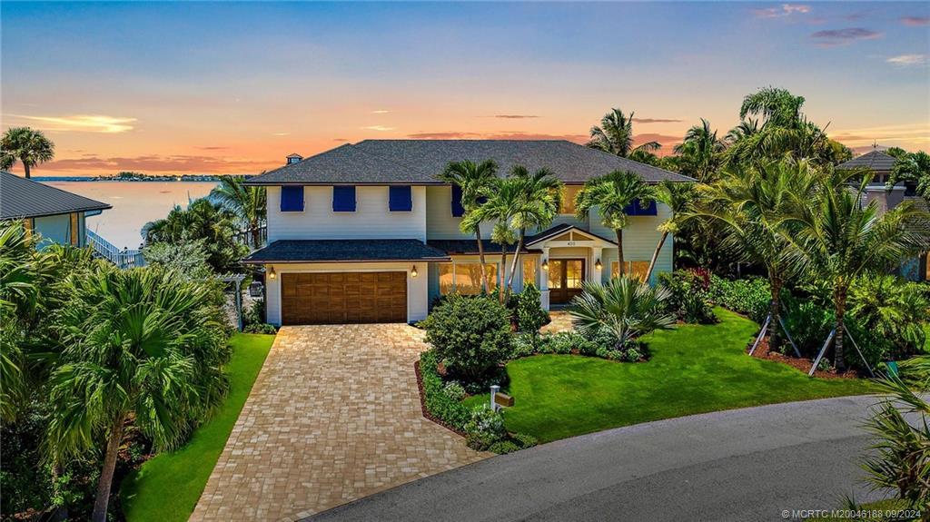 4110 Northeast Joes Point Road Stuart, FL 34996 - Photo 25 of 67 a front view of a house with a yard