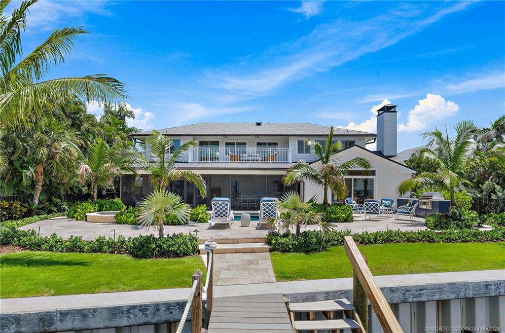 4110 Northeast Joes Point Road Stuart, FL 34996 - Photo 3 of 67 a front view of a house with garden