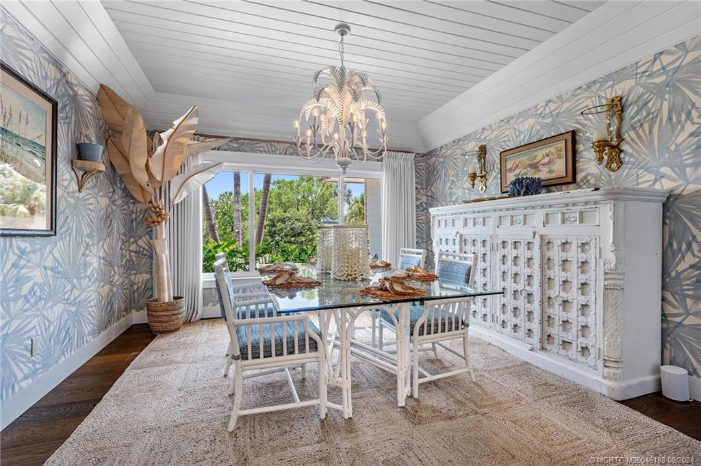 4110 Northeast Joes Point Road Stuart, FL 34996 - Photo 37 of 67 a dining room with furniture a chandelier and window
