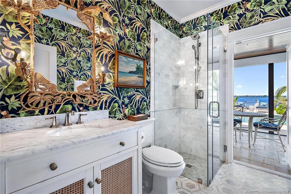 4110 Northeast Joes Point Road Stuart, FL 34996 - Photo 38 of 67 a bathroom with a sink a toilet and shower