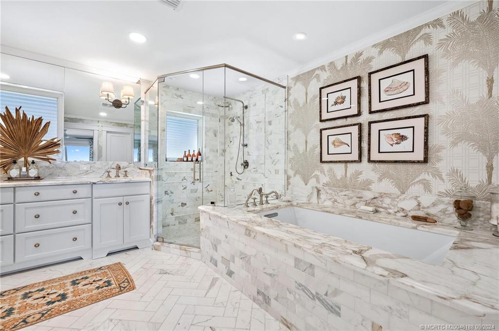 4110 Northeast Joes Point Road Stuart, FL 34996 - Photo 53 of 67 a spacious bathroom with a double vanity sink a mirror a bathtub and shower