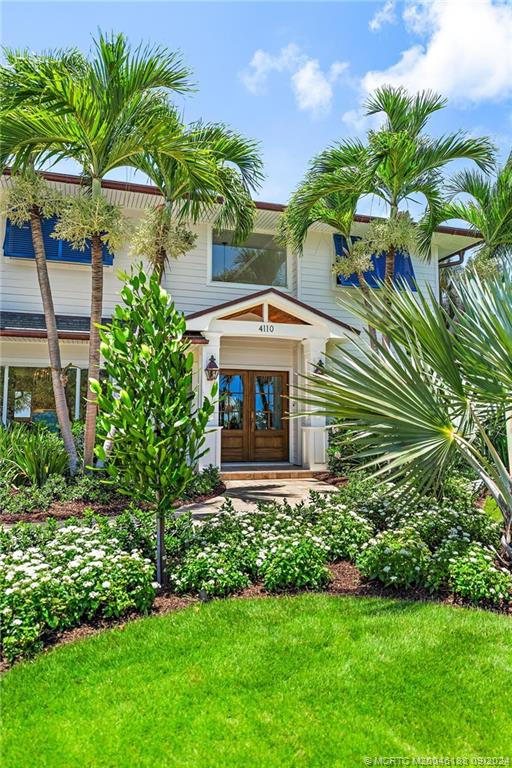 4110 Northeast Joes Point Road Stuart, FL 34996 - Photo 6 of 67 a front view of a house with a garden