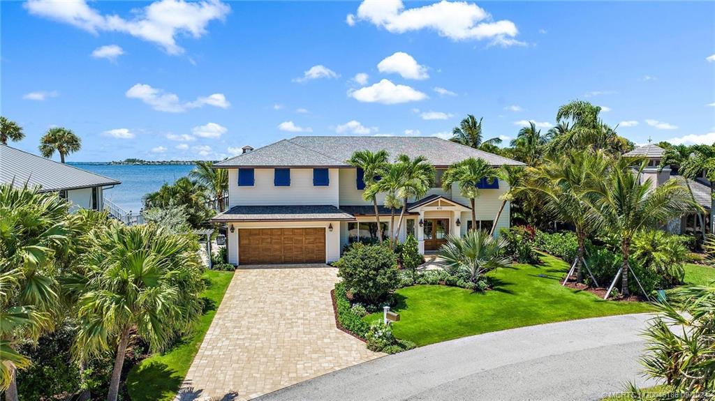 4110 Northeast Joes Point Road Stuart, FL 34996 - Photo 65 of 67 a front view of a house with a yard and potted plants