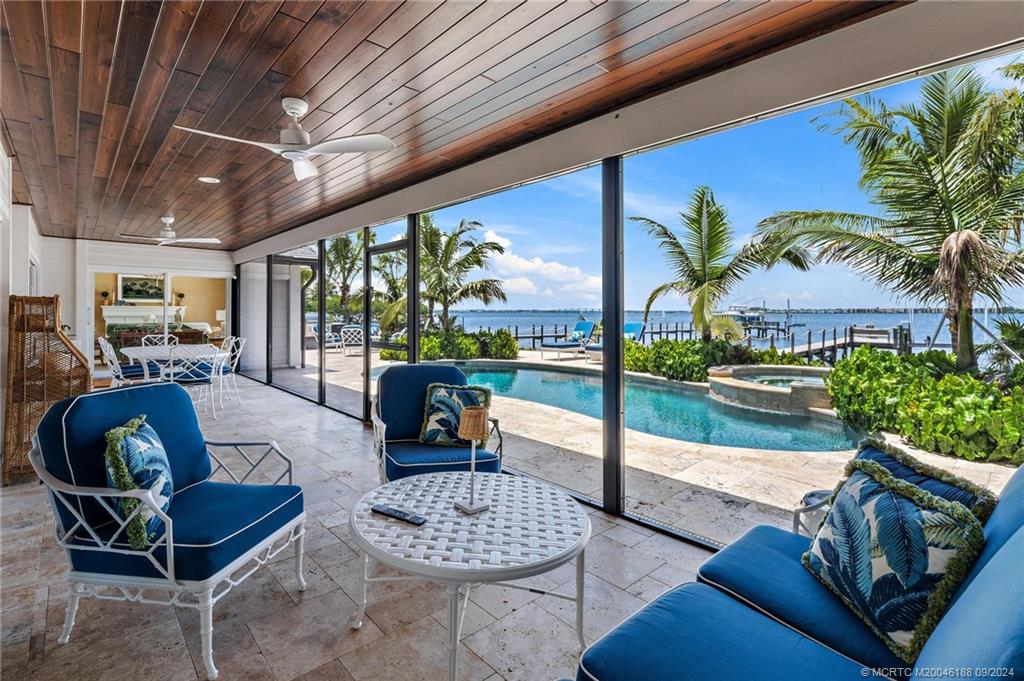 4110 Northeast Joes Point Road Stuart, FL 34996 - Photo 9 of 67 a living room with furniture and a large window