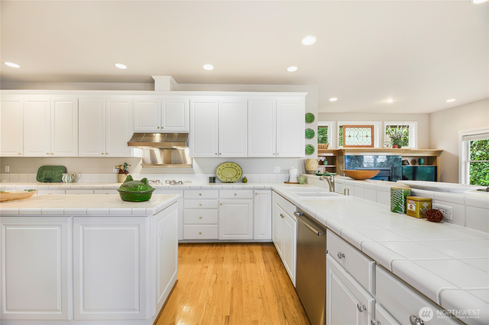 621 Southwest 295th Place Federal Way, WA 98023 - Photo 18 of 35 a kitchen with kitchen island white cabinets appliances and a counter top space