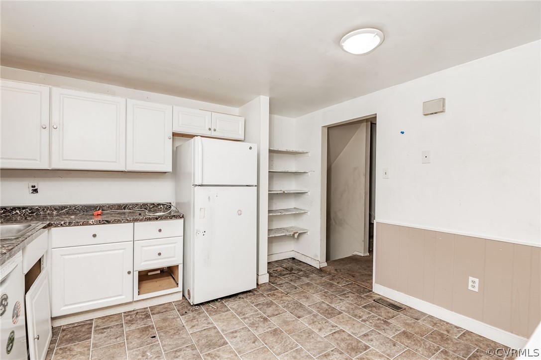 9333 Carbe Road North Chesterfield, VA 23236 - Photo 12 of 34 a kitchen with cabinets and white appliances