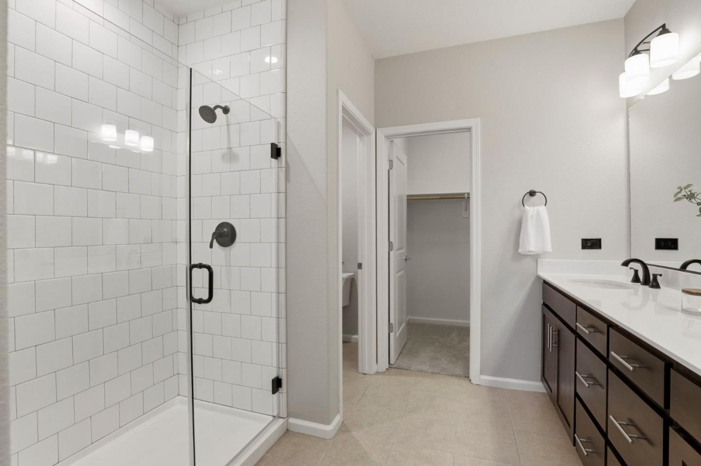 172 East Main Avenue Morgan Hill, CA 95037 - Photo 18 of 36 a bathroom with a double vanity sink a mirror and shower