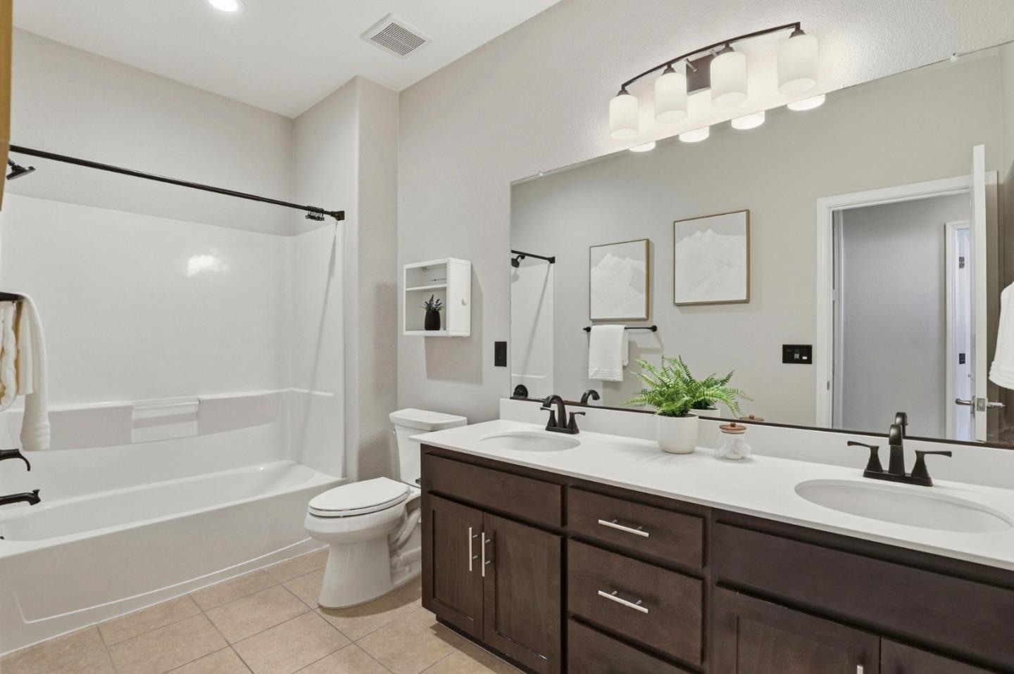 172 East Main Avenue Morgan Hill, CA 95037 - Photo 21 of 36 a bathroom with a double vanity sink toilet mirror and bathtub