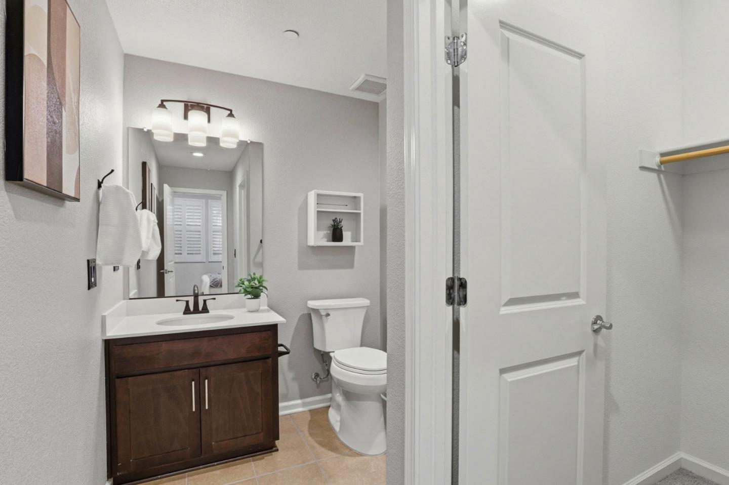 172 East Main Avenue Morgan Hill, CA 95037 - Photo 27 of 36 a bathroom with a double vanity sink mirror and toilet