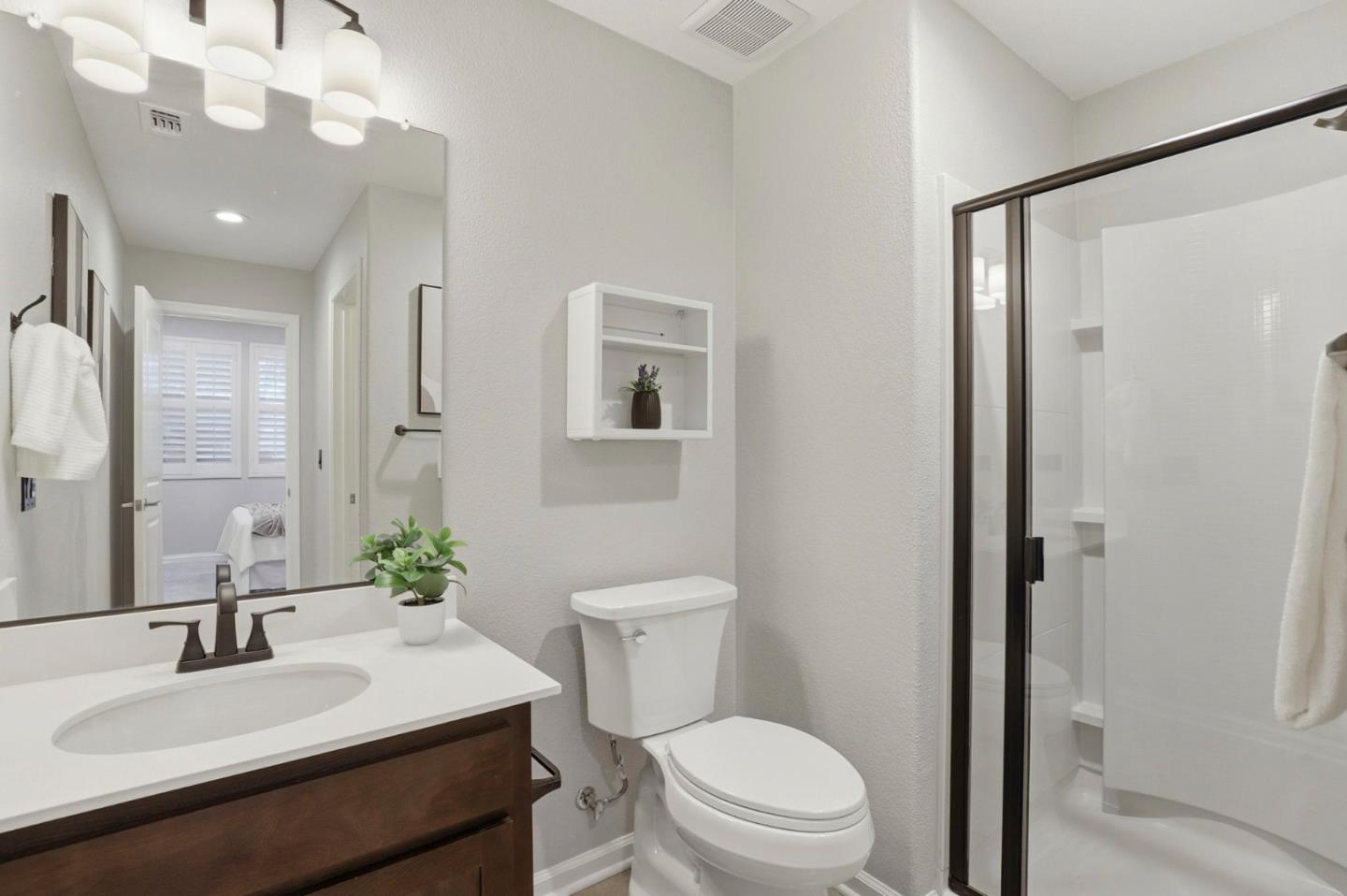 172 East Main Avenue Morgan Hill, CA 95037 - Photo 28 of 36 a bathroom with a sink vanity granite toilet and a mirror