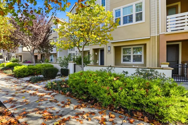 a kitchen with stainless steel appliances granite countertop a sink stove refrigerator and cabinets