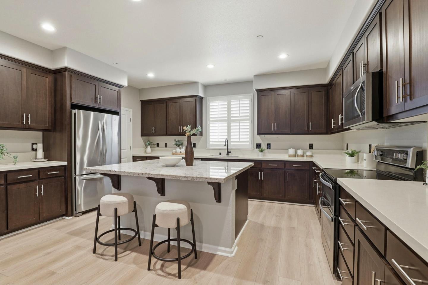 172 East Main Avenue Morgan Hill, CA 95037 - Photo 9 of 36 a kitchen with stainless steel appliances granite countertop a sink stove refrigerator and cabinets