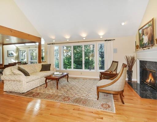 1115 North Road Carlisle, MA 01741 - Photo 11 of 30 a living room with furniture a fireplace and a flat screen tv