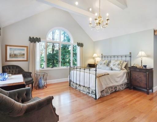 1115 North Road Carlisle, MA 01741 - Photo 14 of 30 a spacious bedroom with a bed and a chandelier