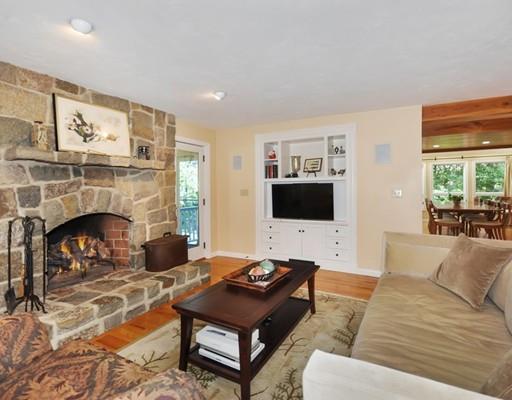 1115 North Road Carlisle, MA 01741 - Photo 7 of 30 a living room with furniture a flat screen tv and a fireplace