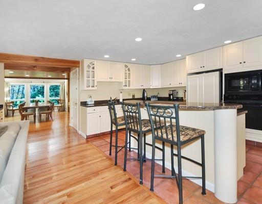 1115 North Road Carlisle, MA 01741 - Photo 9 of 30 a kitchen with stainless steel appliances wooden floors and white cabinets