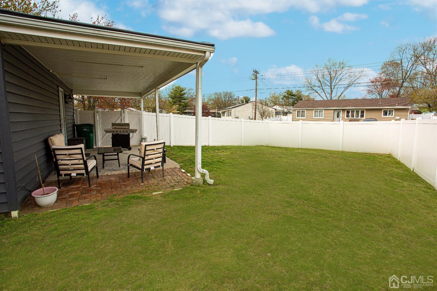 50 Harvard Road Old Bridge, NJ 08859 - Photo 8 of 44 a view of a patio with table and chairs with wooden floor and fence