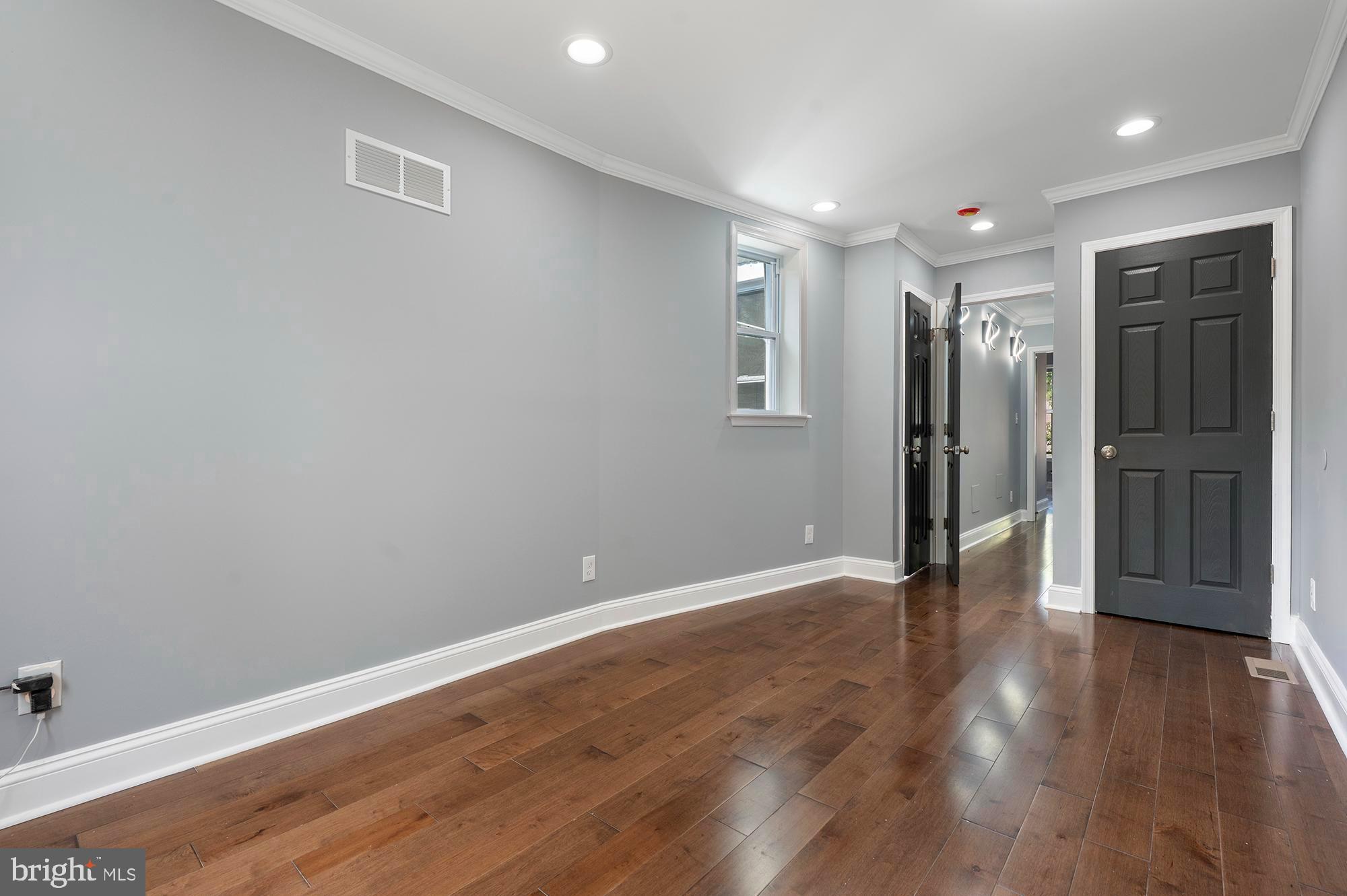 1513 North Wolfe Street Baltimore, MD 21213 - Photo 18 of 33 a view of an empty room with wooden floor and closet