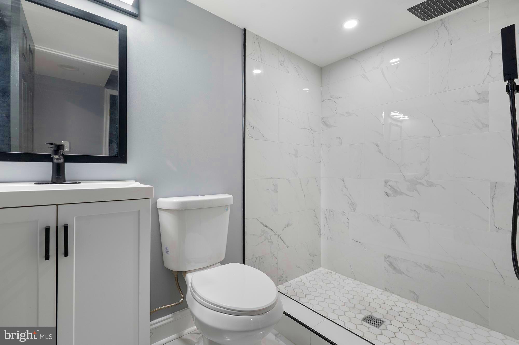 1513 North Wolfe Street Baltimore, MD 21213 - Photo 25 of 33 a bathroom with a sink a toilet and shower