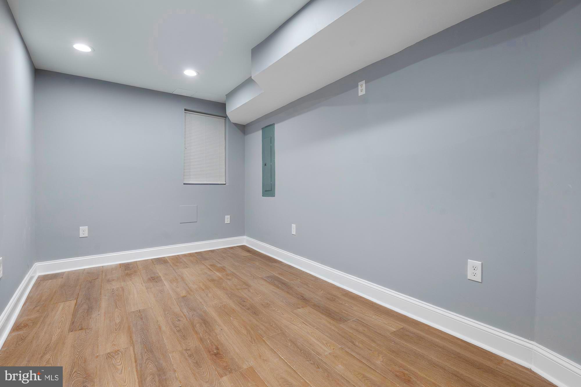 1513 North Wolfe Street Baltimore, MD 21213 - Photo 27 of 33 an empty room with wooden floor and windows