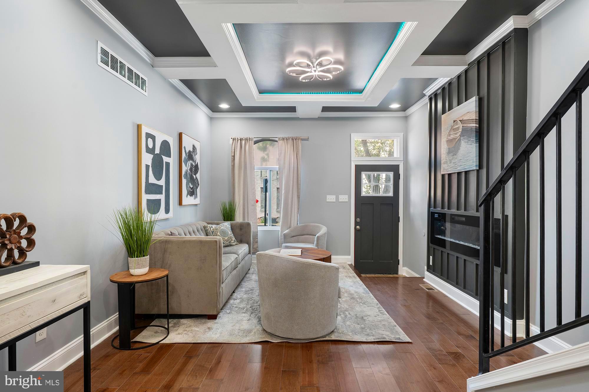 1513 North Wolfe Street Baltimore, MD 21213 - Photo 3 of 33 a living room with furniture and a chandelier