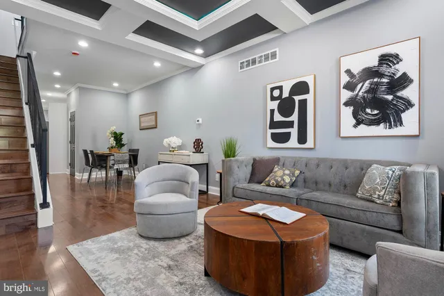 a living room with furniture and wooden floor