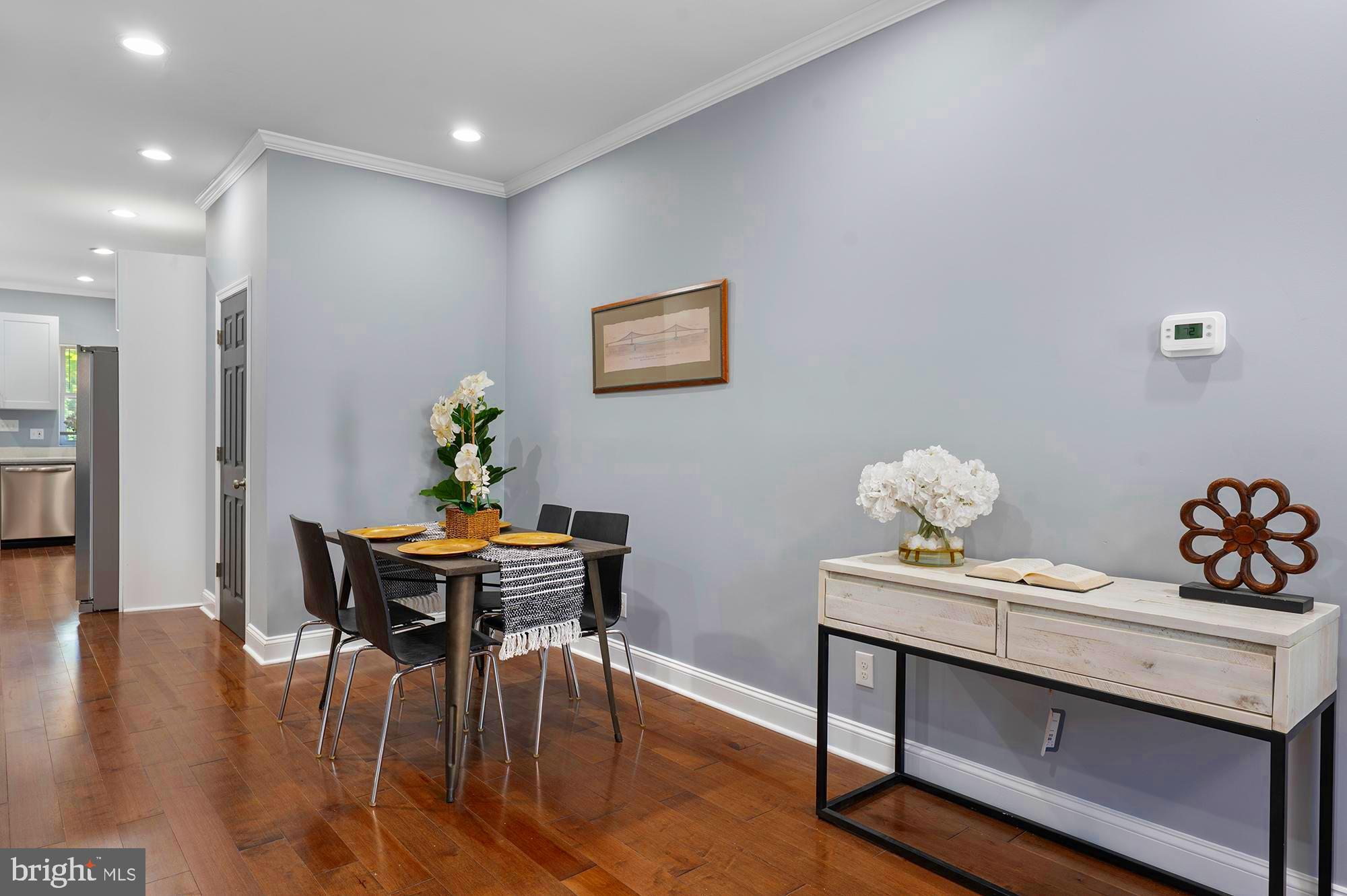 1513 North Wolfe Street Baltimore, MD 21213 - Photo 5 of 33 a view of a dining room with furniture and wooden floor