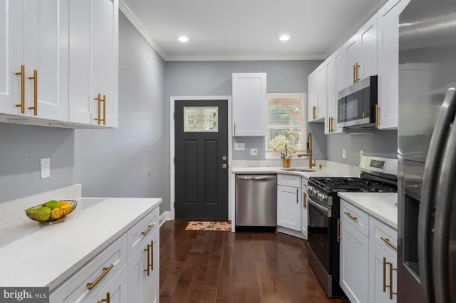 a kitchen with a sink a stove and refrigerator