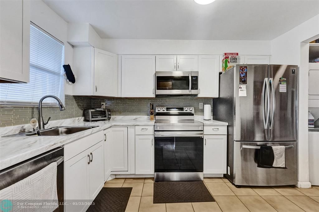 a kitchen with a refrigerator sink and microwave