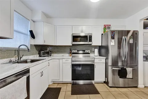 a kitchen with a refrigerator sink and microwave