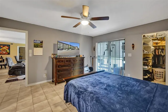 a living room with a bed and a flat screen tv