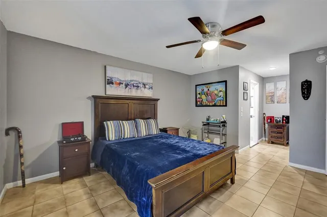 a bedroom with a bed and a dresser in it