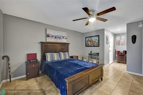 a living room with a bed and a flat screen tv