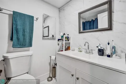 a bathroom with a sink a toilet and mirror