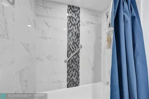 a bathroom with a bathtub and shower