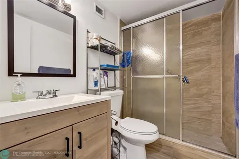 a bathroom with a sink toilet and shower