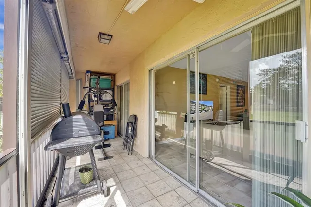 a view of a two chair and table in the balcony