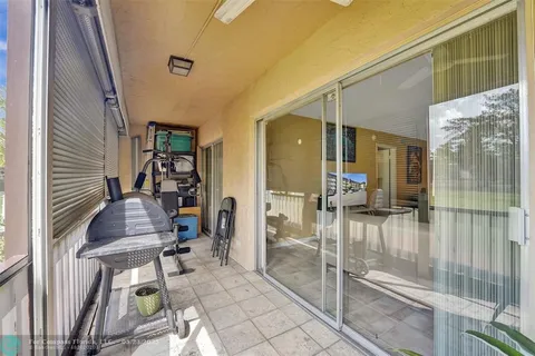 a view of a two chairs and table in patio