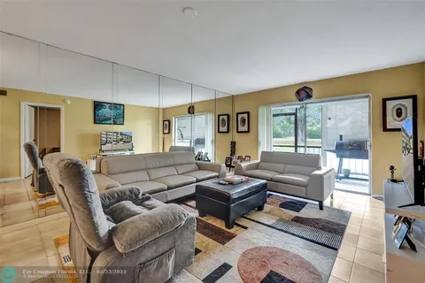 a living room with furniture wooden floor and a flat screen tv