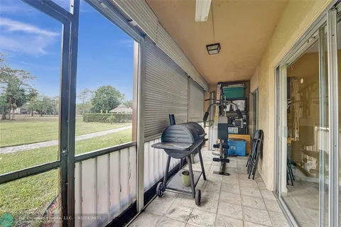 a porch with a table and chairs
