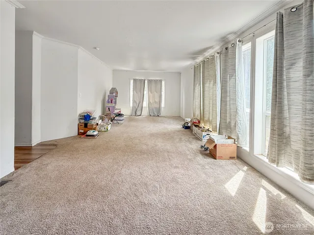 a view of a room with gym equipment and a large window