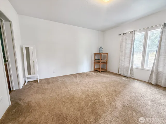 a view of empty room with a fireplace