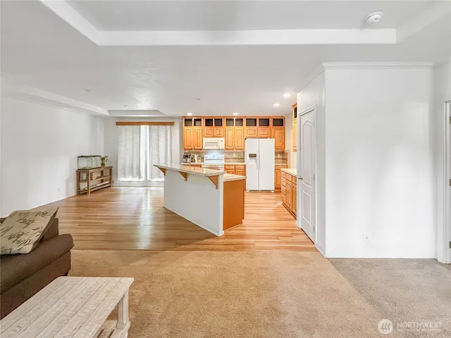 a living room with furniture and a kitchen