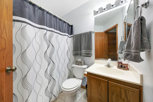 a bathroom with a sink toilet and mirror