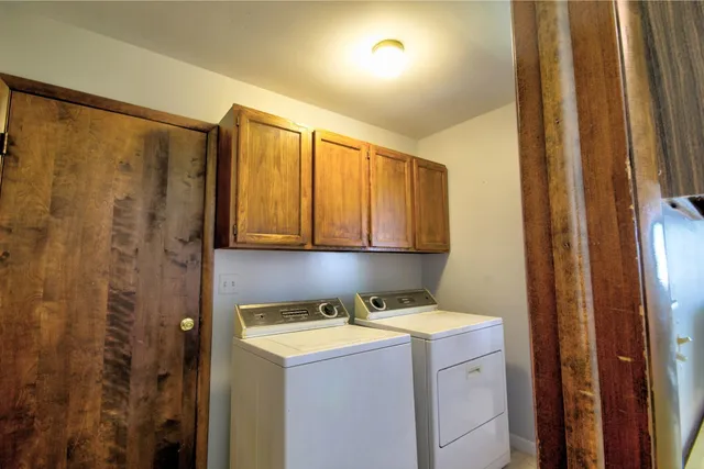 a kitchen with stainless steel appliances granite countertop a sink a stove a refrigerator and cabinets