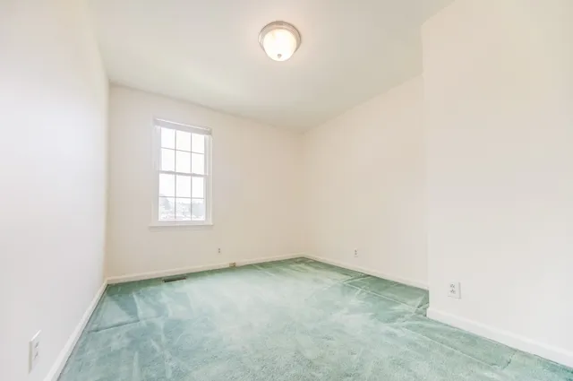 an empty room with a empty space and window